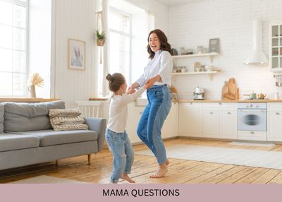 A woman and child hold hands and dance together in a bright living room.